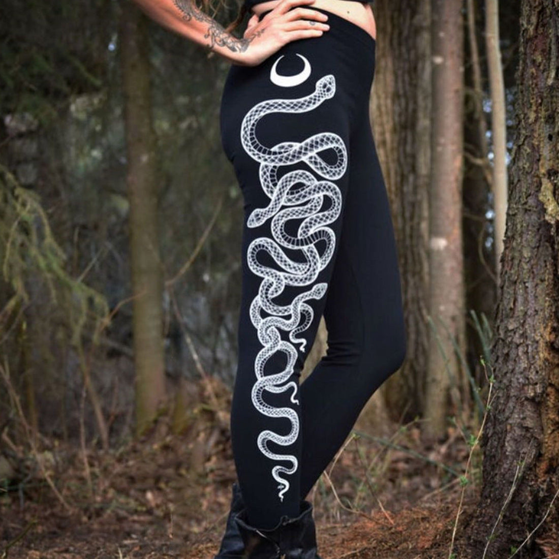 "Bold white snake illustration on black yoga leggings, comfortable polyester tights for gym classes and casual wear"