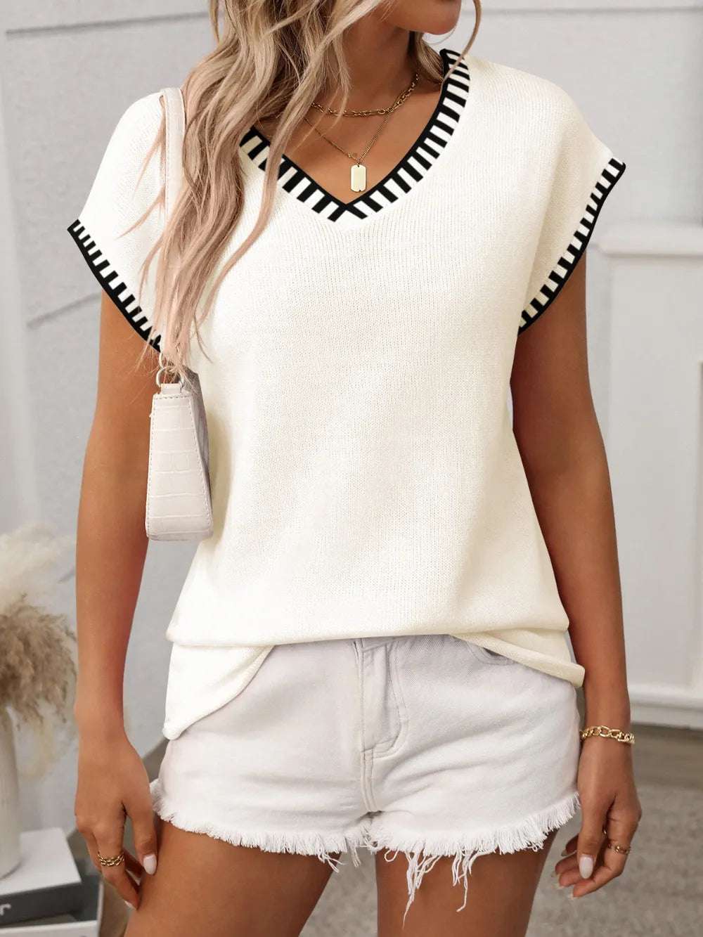 Woman’s knit top with short sleeves and contrast neckline, casual style