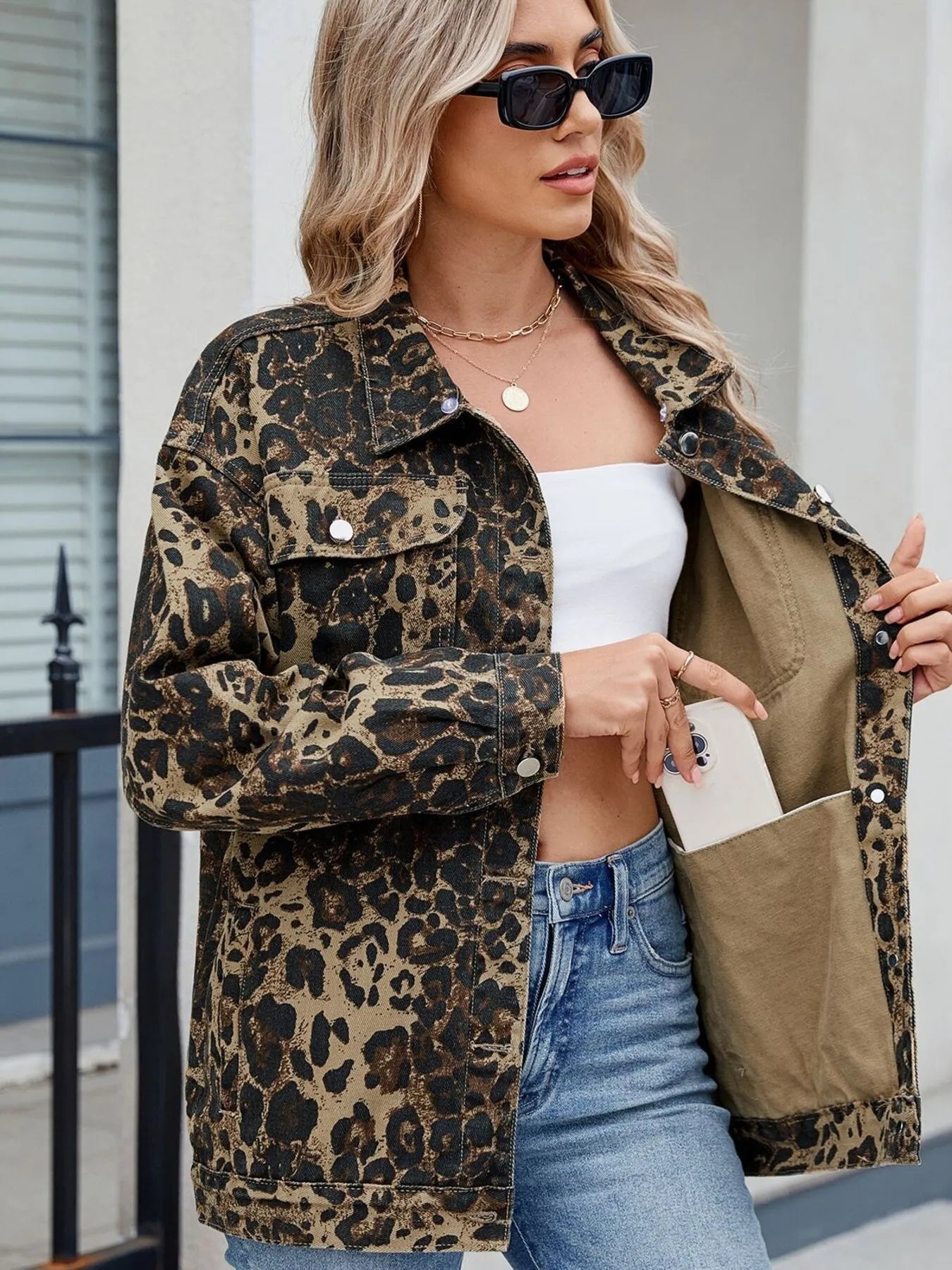 Linen backdrop highlights the golden tones of the Leopard Print Jean Jacket.