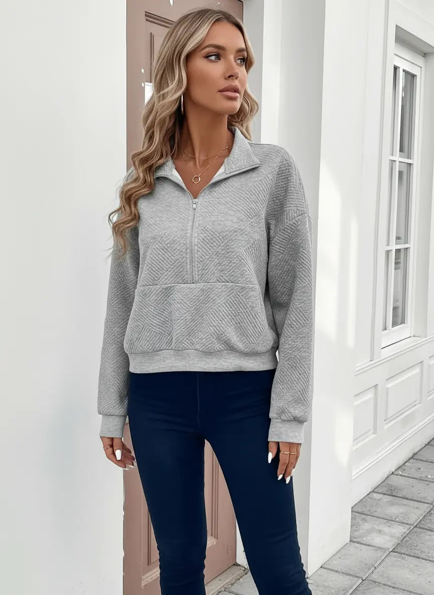 Model wearing textured half zip long sleeve women's sweatshirt in neutral tones, demonstrating versatile fit for everyday occasions.
