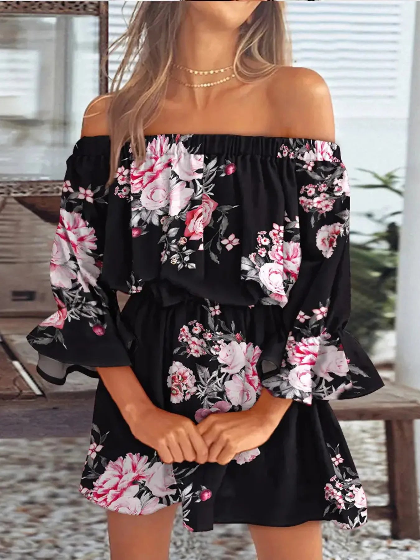 Plus size figure flaunts flounce sleeve movement on sunlit patio.
