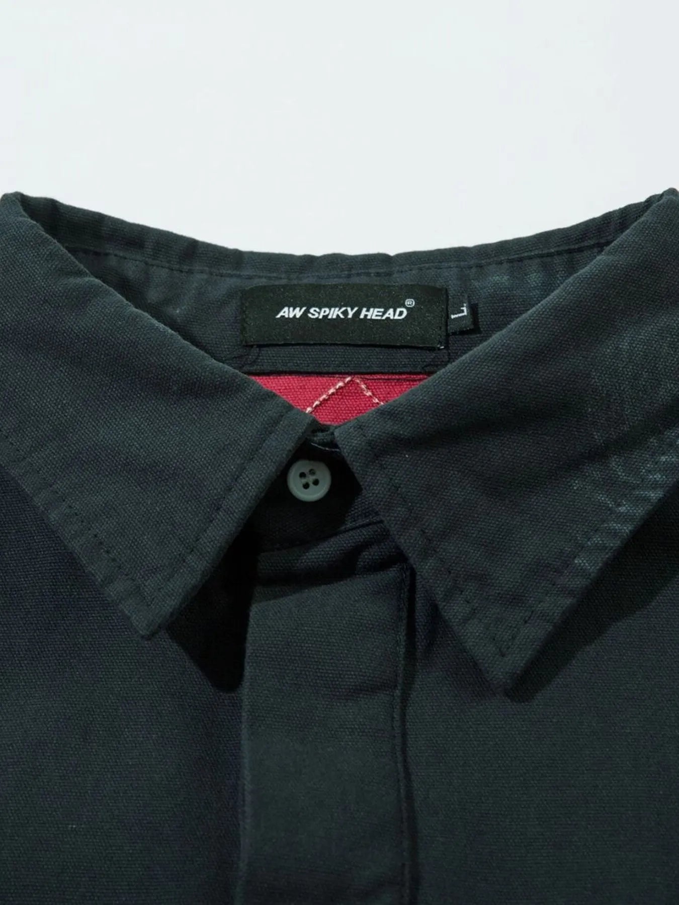 Zoom-in on embroidered letter detail on black sweatshirt
