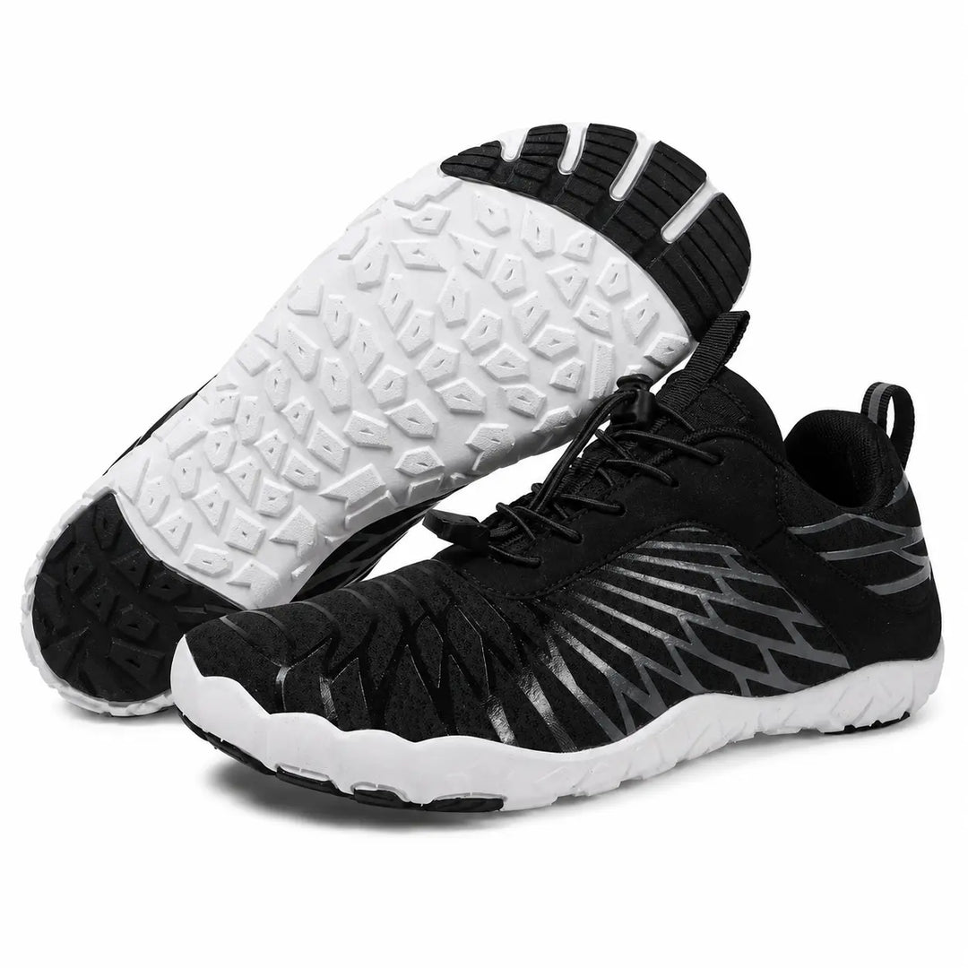 Black unisex slip-on hiking shoes with mesh uppers and segmented white outsoles, shown as a pair on a clean white background.