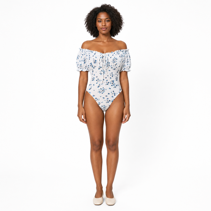 Floral bodysuit for women with puff sleeves and square neckline, shown from the front on a professional studio model.