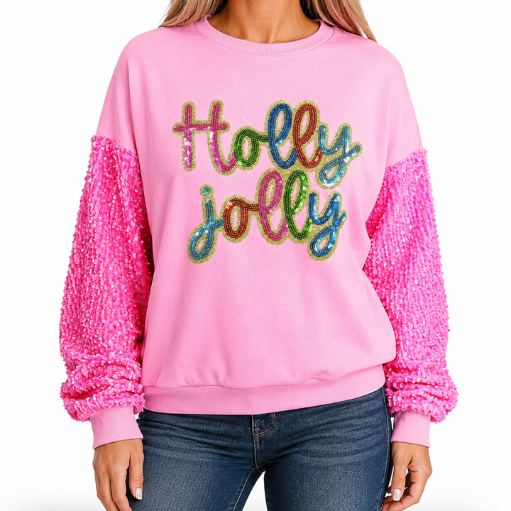Front fit of pink Holly Jolly sequin sweatshirt styled with blue jeans