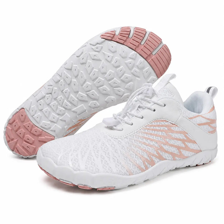 White and pink unisex slip-on hiking shoes with mesh uppers and segmented soles, shown as a pair on a clean white background.