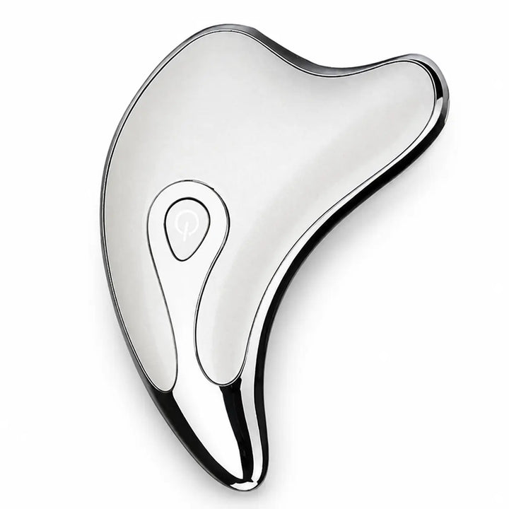 Silver facial massage tool on a white studio background, showing its curved edges, reflective finish and a main power button.
