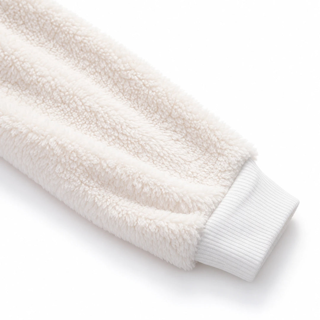 Close-up of ivory fleece fabric and ribbed white cuff on women&