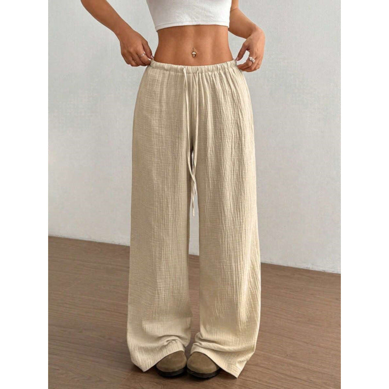 Beige wide-leg pants worn by a person on a plain background