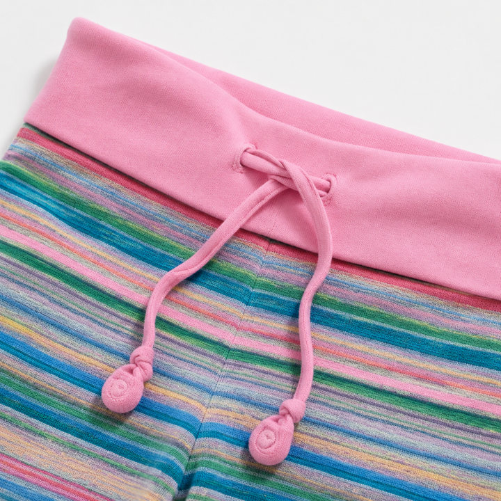 Close view of Pink fold-over waistband and center drawstring on striped pants, showing visible stitching and product details.