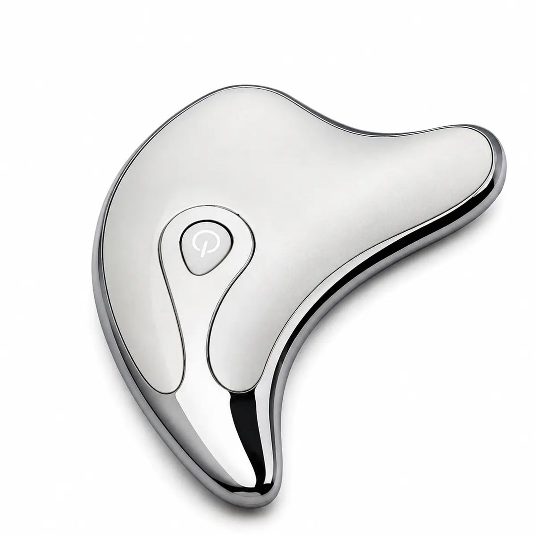 Silver face and body massage tool in a close top product view, showing its smooth finish, dark rim and teardrop control area.