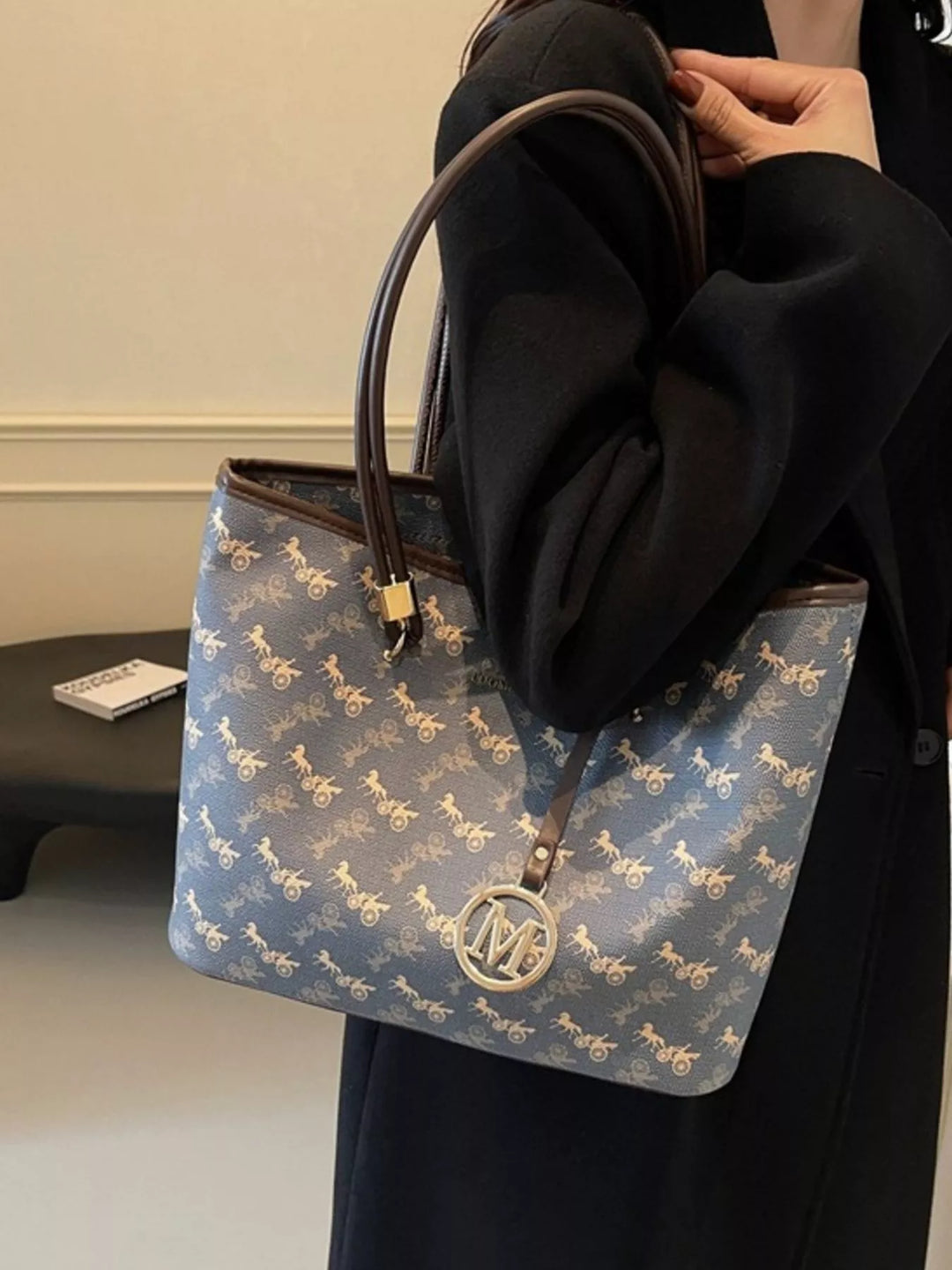 Travel tote bag styled with passport, scarf, cosmetics, and neutral accessories.