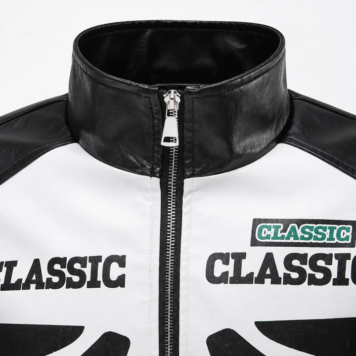 Close-up of the Black jacket high stand collar and center zipper, with contrast white panel edge and graphic detail, in view.