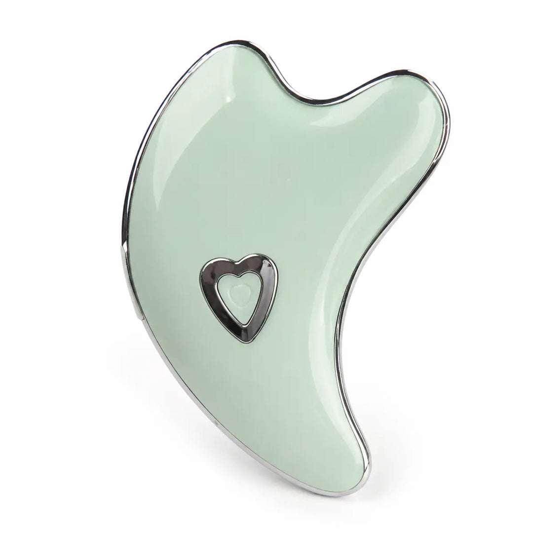 Mint Green facial massage tool on a white studio background with chrome edging, curved lines and a heart-shaped power button.