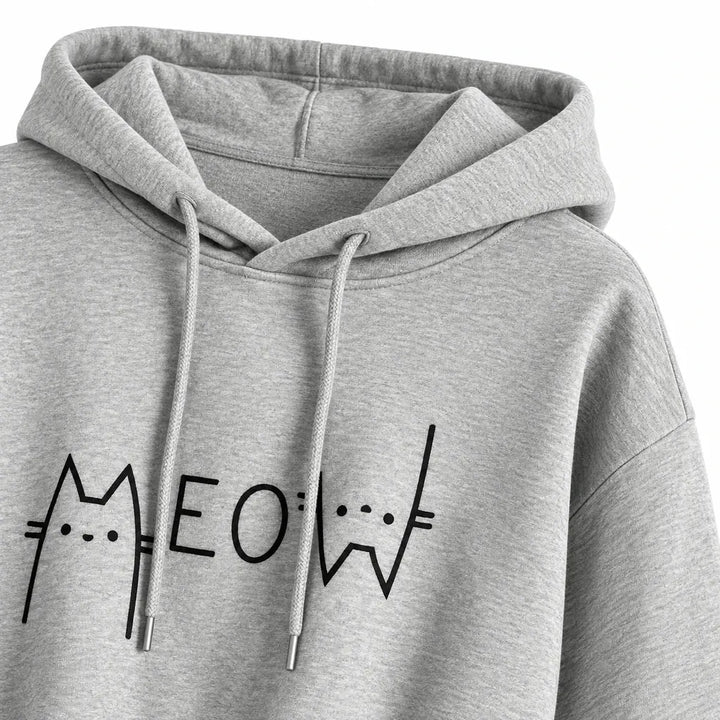Close-up of a heather gray hood, matching drawstrings and dropped shoulder seam, with part of the black Meow graphic visible.