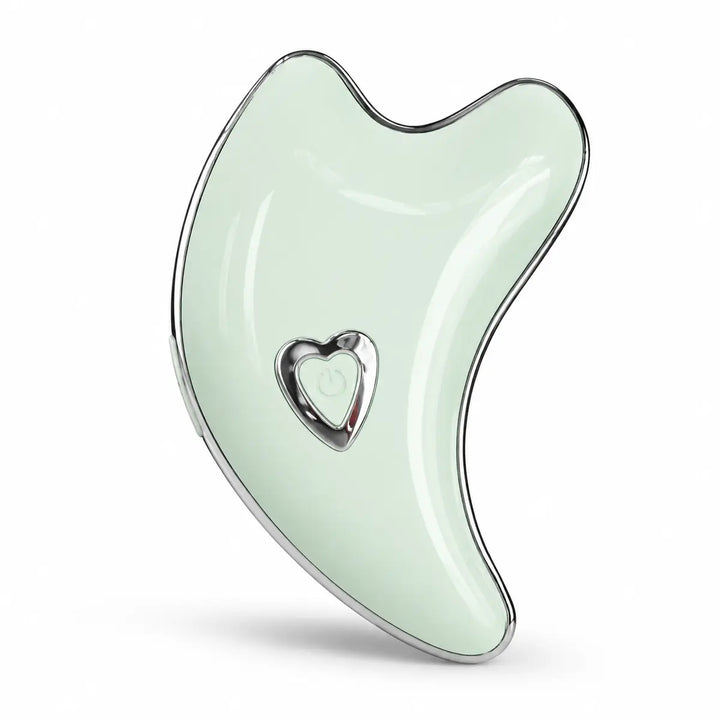 Mint Green face and body massage tool in a detailed side view highlighting its glossy finish, curved edge and chrome accents.
