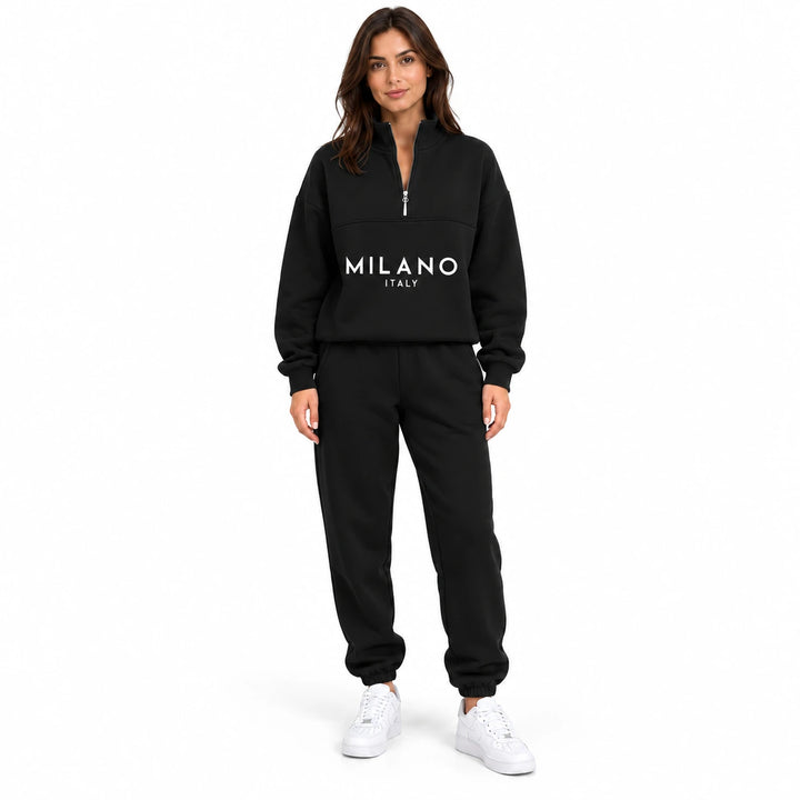 Woman wearing the black half zip sweatshirt and jogger set with white MILANO ITALY print