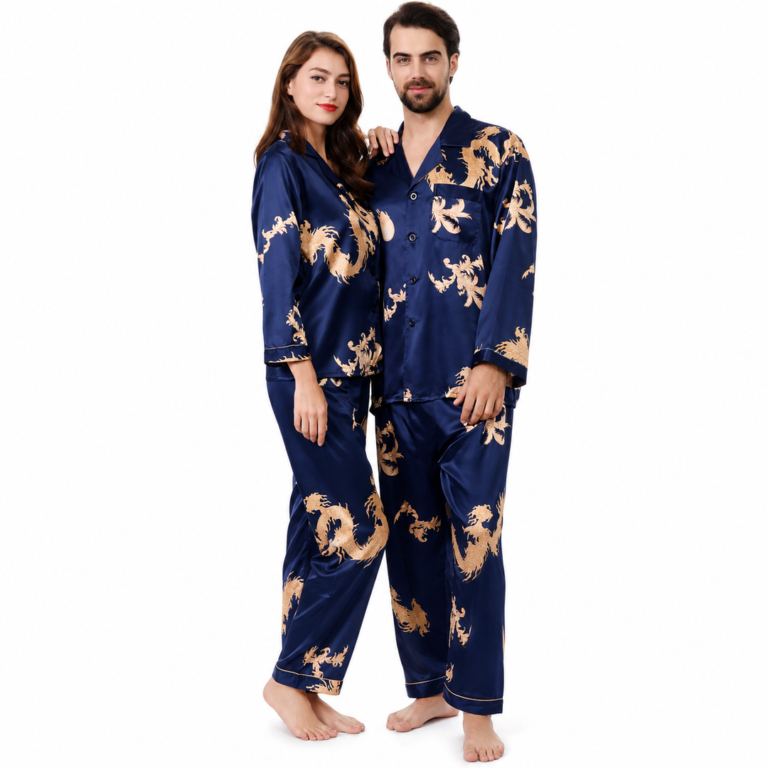 Royal blue matching couple pajamas on a man and woman, with gold dragon and phoenix print, long sleeves and coordinated pants.