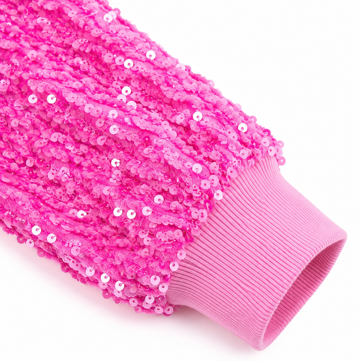 Close-up of bright pink sequin sleeve and ribbed cuff detail
