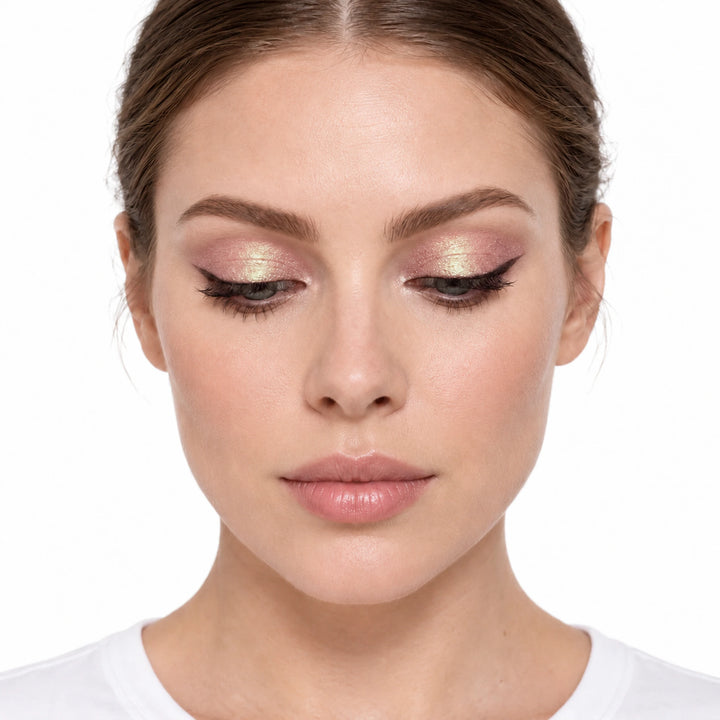 PHOERA Pinch Me liquid eyeshadow shown as rose shimmer with golden reflections on a model against white