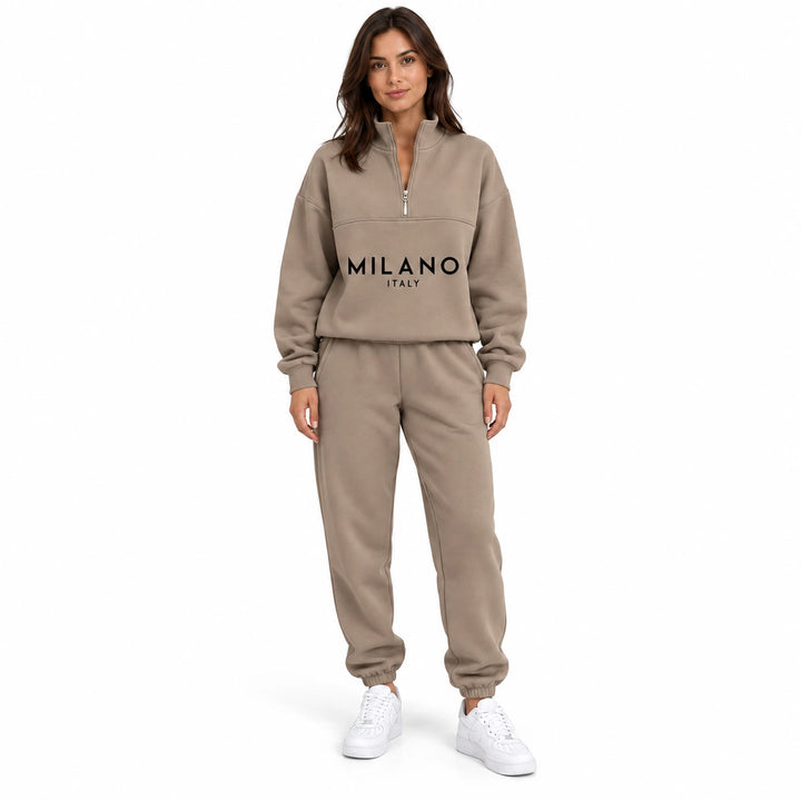 Woman wearing the camel half zip sweatshirt and matching joggers with black letter print