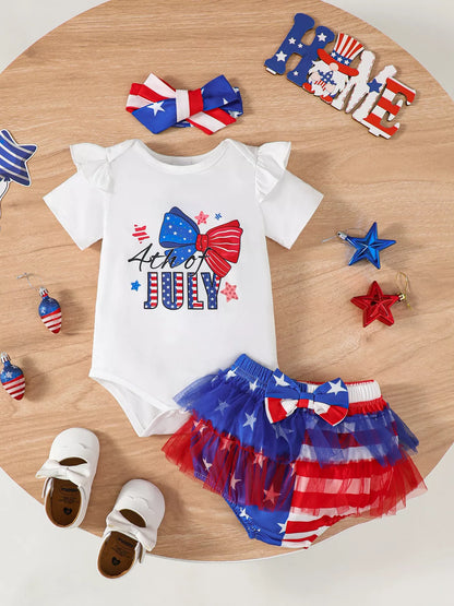 US flag baby outfit close-up of bow graphic and 4th of July lettering on white romper top for summer parade styling
