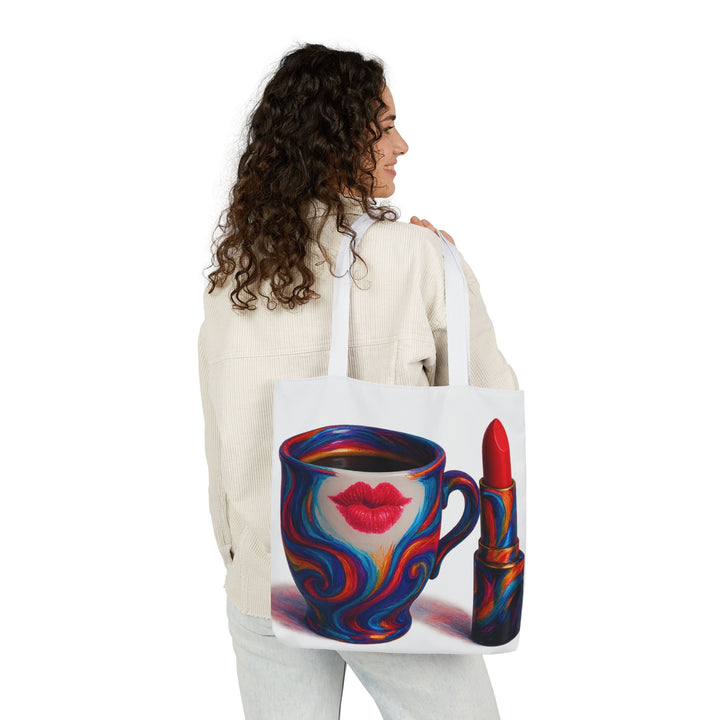 Woman holding a tote bag with a colorful design of a coffee cup and lipstick.