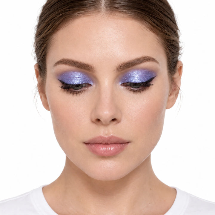 PHOERA Viridian liquid eyeshadow shown as violet blue shimmer on a model against white