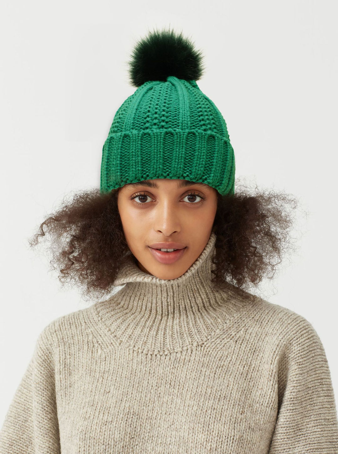 Green satin lined pom pom beanie hat with silky inner layer, cozy knit that looks three times more expensive than price