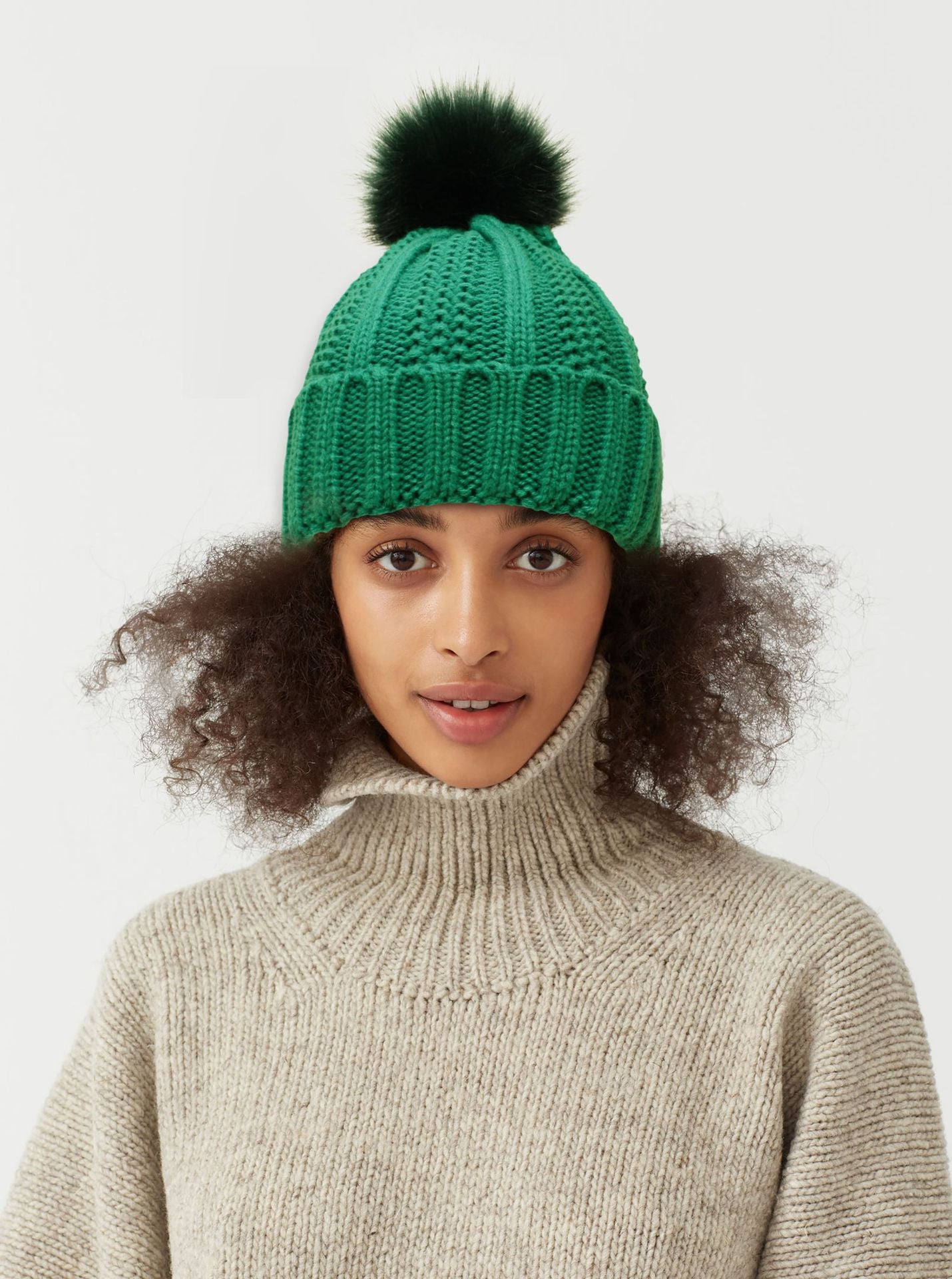 Green satin lined pom pom beanie hat with silky inner layer, cozy knit that looks three times more expensive than price