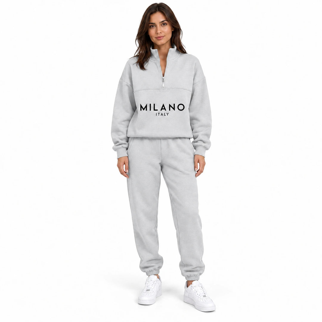 Woman wearing the pale heather gray White half zip sweatshirt and matching jogger set