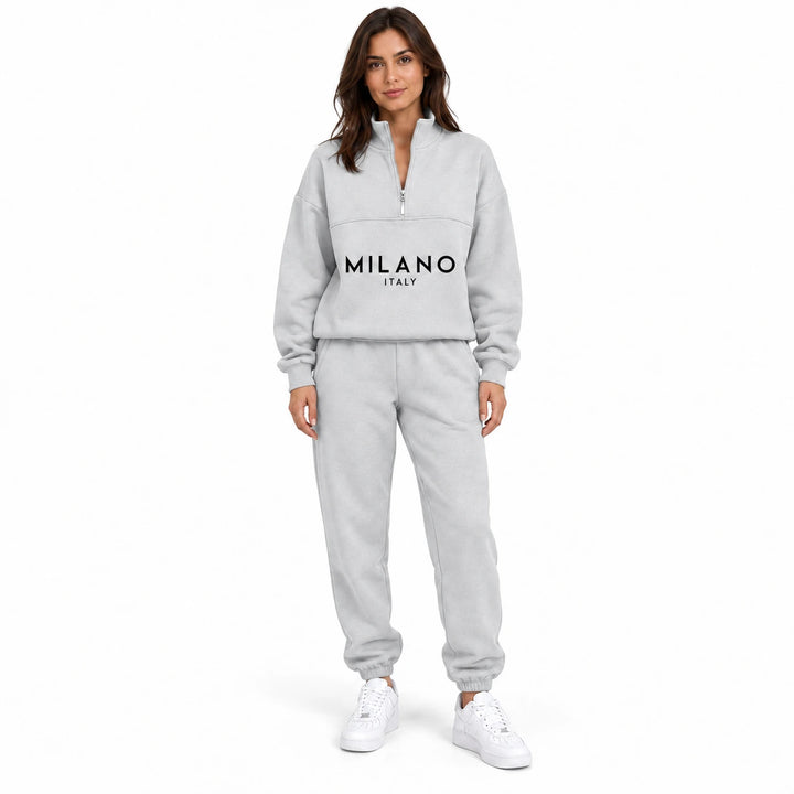 Woman wearing the pale heather gray White half zip sweatshirt and matching jogger set