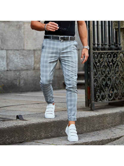 men's plaid pants styled with hoodie and boots showing loose fit plaid print trousers for men with streetwear edge