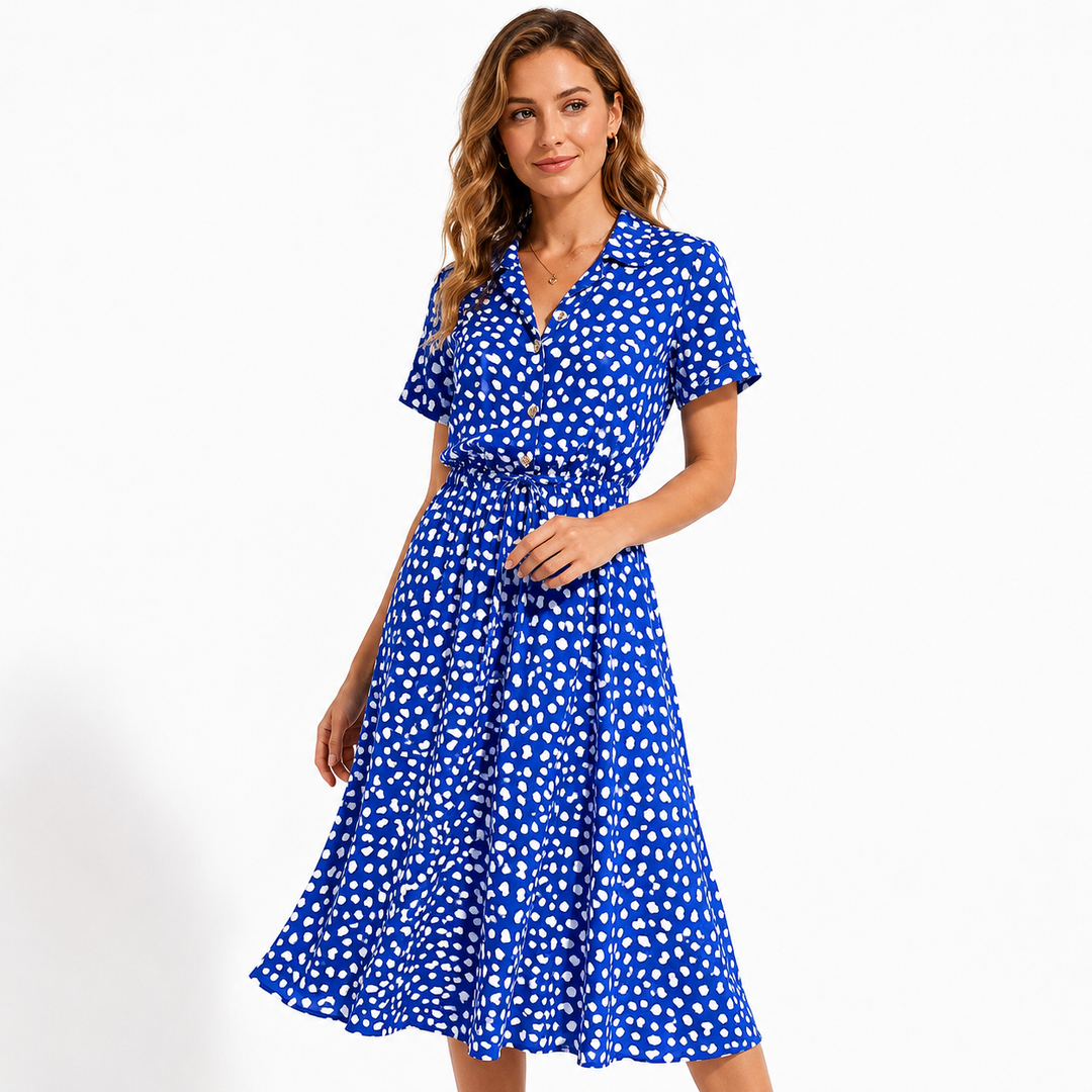 Elegant polka dot chiffon dress front view with soft movement, shirt collar and flattering high waist shape for summer days..