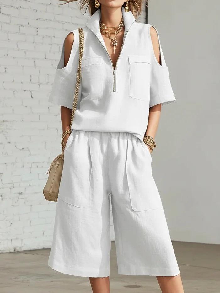 Three-quarter angle view of the model walking, outfit catching light to show fabric texture