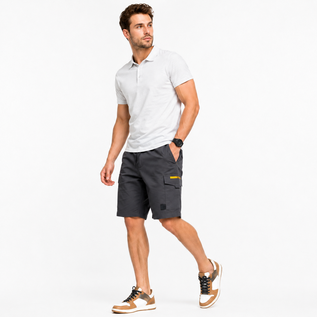 Man wearing a white polo shirt and gray shorts on a white background