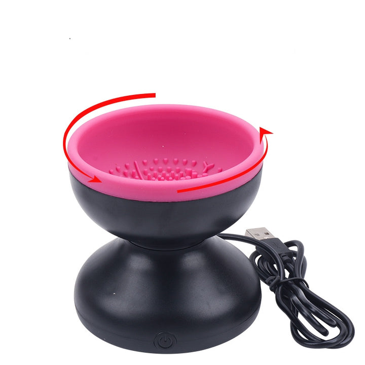 Black and pink electronic device with USB cable on a white background
