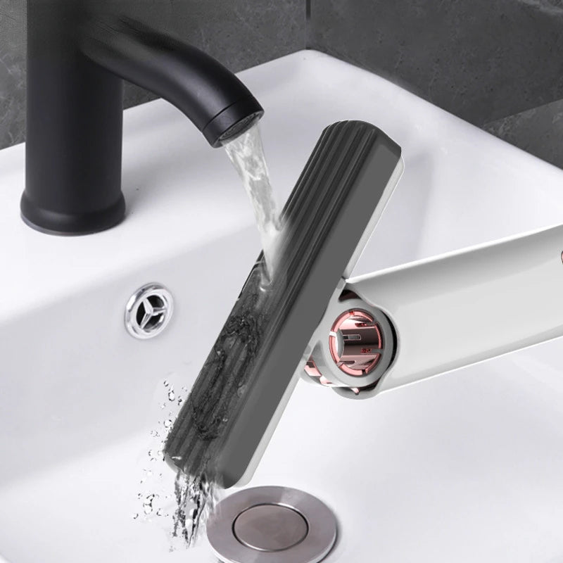 Black faucet with water flowing into a sink