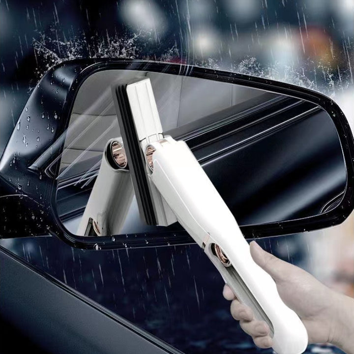 Person cleaning a car mirror with a white cleaning tool in rainy conditions.