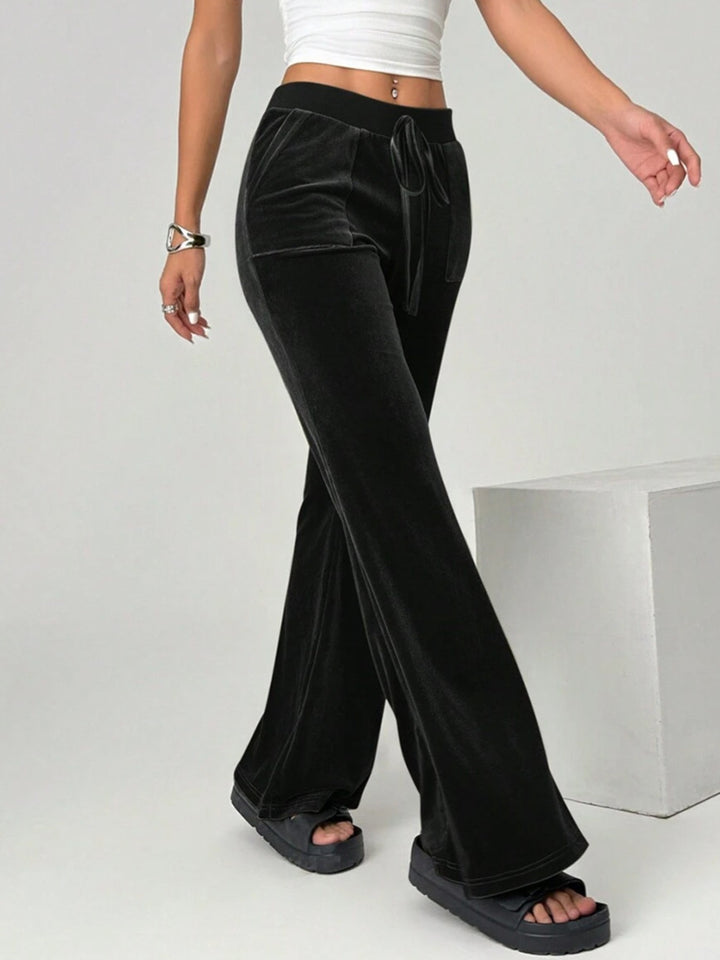 velvet flare pants premium fabric shine subtle light reflection studio context