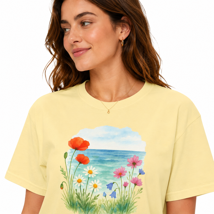 Woman wearing a yellow t-shirt with a floral design on a white background