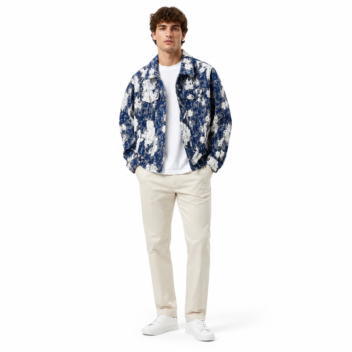 Man wearing a blue floral shirt, white t-shirt, and beige pants on a white background