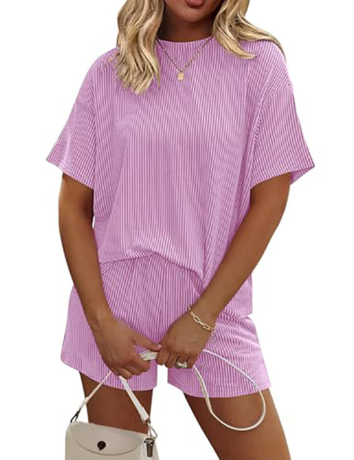 Woman wearing a pink and white striped outfit on a white background