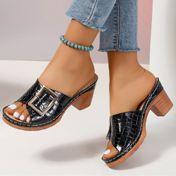 Women’s buckle sandals shown from side angle with heel height detail