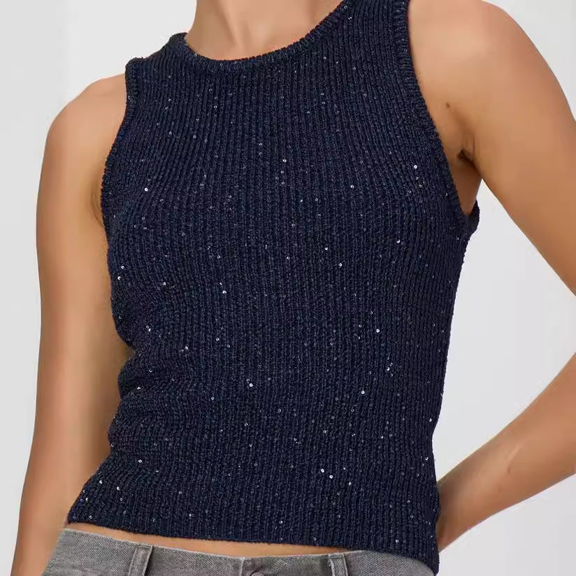 Navy blue sparkly sleeveless top worn by a model on a light gray background
