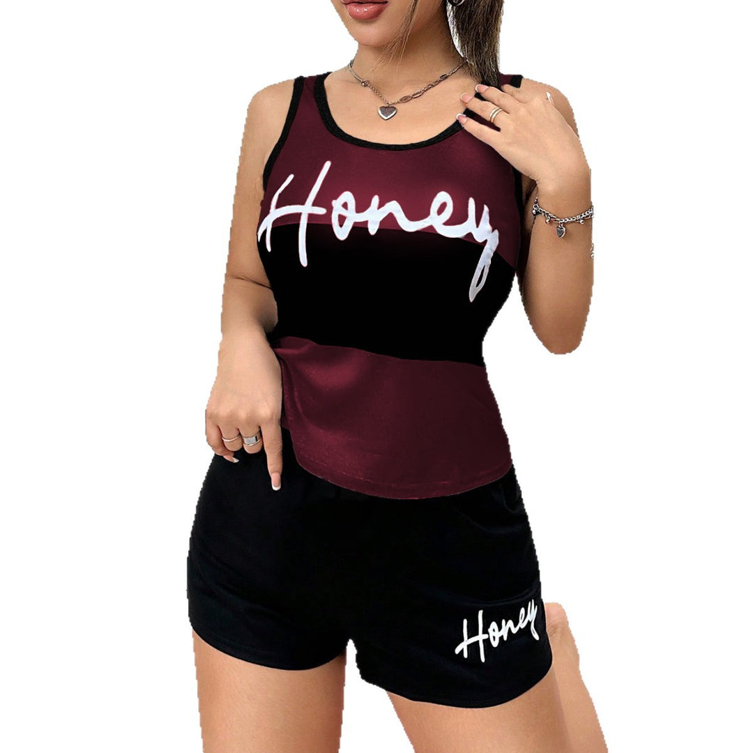 Woman wearing a black and burgundy tank top and shorts set with &