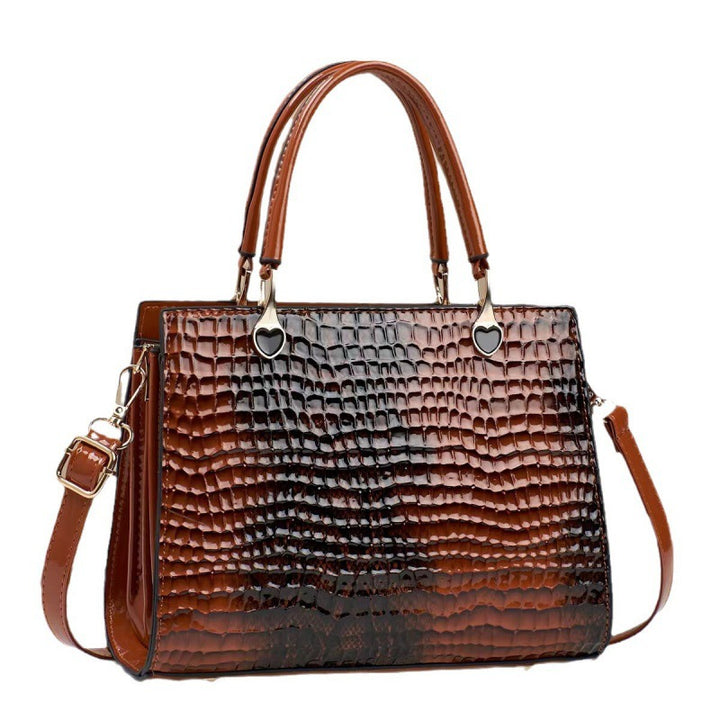 Brown textured handbag with shoulder strap on a white background