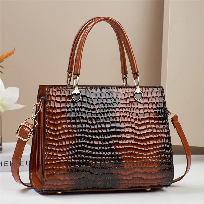 Brown textured handbag with a shoulder strap on a light background