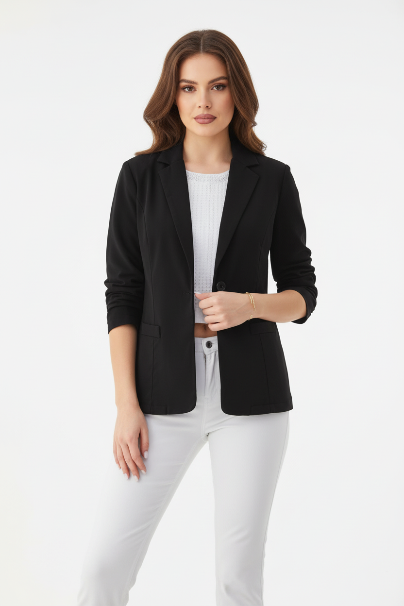 Woman wearing a black blazer over a white top and pants on a white background