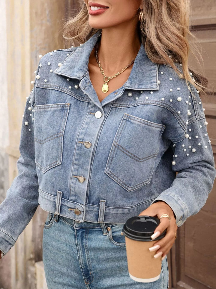 statement denim jacket pearl accents reflecting light minimalist styling